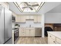 This bright kitchen features stainless steel appliances and tile backsplash at 14300 E Marina Dr # 306, Aurora, CO 80014
