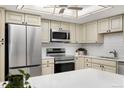 A bright kitchen features stainless steel appliances and solid surface countertops at 14300 E Marina Dr # 306, Aurora, CO 80014