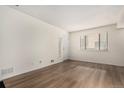 Bright living room with hardwood floors and large window at 9255 E Lehigh Ave # 211, Denver, CO 80237