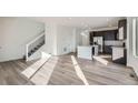 Open concept kitchen and living area with hardwood floors and island at 14586 W 91St Ave # A, Arvada, CO 80005