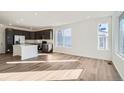 Modern kitchen with dark cabinetry, island, and stainless steel appliances at 14586 W 91St Ave # A, Arvada, CO 80005