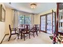 Bright dining room featuring a classic wooden table set, large window with natural light, and elegant drapery at 3724 S Poplar St, Denver, CO 80237