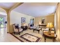 Inviting living room with classic furnishings, neutral tones, arched doorways and access to other rooms at 3724 S Poplar St, Denver, CO 80237