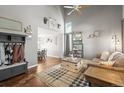 Bright living room with high ceilings, hardwood floors, and decor accents at 2602 E 145Th Ave, Thornton, CO 80602