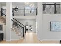 Beautiful two-story foyer with hardwood floors, modern staircase, and access to an outdoor patio at 4505 S Yosemite St # 362, Denver, CO 80237