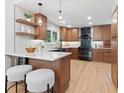 Beautiful kitchen featuring a breakfast bar, stainless steel appliances, and wooden cabinetry at 4505 S Yosemite St # 362, Denver, CO 80237