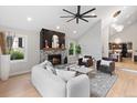 Bright living room with fireplace, ceiling fan, and view into dining room at 4505 S Yosemite St # 362, Denver, CO 80237
