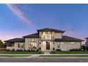 Elegant home exterior showcasing stone accents, a dark roof, a balcony, and lush landscaping at 14545 Lipan St, Westminster, CO 80023