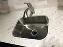 Close-up of stainless steel kitchen sink with modern faucet and granite countertop at 5875 E Iliff Ave # 203, Denver, CO 80222