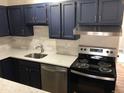 Updated kitchen with stainless steel appliances, white backsplash, and updated cabinetry at 5875 E Iliff Ave # 203, Denver, CO 80222