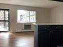 Bright living room with balcony access and an open floor plan at 5875 E Iliff Ave # 203, Denver, CO 80222