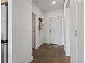 Bright hallway with hardwood floors and white walls leading to various rooms at 1898 S Bannock St # 209, Denver, CO 80223