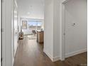 Hallway view showing hardwood floors and access to the living area and bedrooms at 1898 S Bannock St # 209, Denver, CO 80223