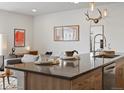 A stylish kitchen island with seating and ample counter space connects to a comfortable living area at 1898 S Bannock St # 209, Denver, CO 80223