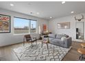 Spacious living room featuring a large window, comfortable seating, and stylish decor at 1898 S Bannock St # 209, Denver, CO 80223