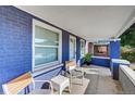 Charming covered front porch with seating, painted brick, and views of the neighborhood at 706 S Lincoln St, Denver, CO 80209