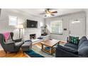 Inviting living room with a decorative fireplace, ceiling fan, and hardwood floors at 706 S Lincoln St, Denver, CO 80209