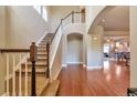 Inviting entryway with hardwood floors, staircase, and seamless flow into the living area at 8537 E 35Th Ave, Denver, CO 80238