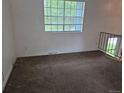 Bedroom with window bringing in natural light, neutral carpet, and electrical outlets at 4678 S Lewiston Way, Aurora, CO 80015
