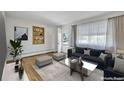Bright, furnished living room with hardwood floors and large windows offering lots of natural light at 505 Maple St, Golden, CO 80403