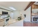 Well-lit kitchen with light-colored countertops and cabinets, with a view of the fireplace at 20 S Boulder Cir # 2303, Boulder, CO 80303