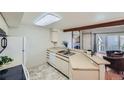 Bright kitchen featuring stainless steel sink, white appliances, and a view of the living room at 20 S Boulder Cir # 2303, Boulder, CO 80303