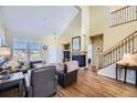 Bright living room featuring soaring ceilings, a cozy fireplace, and gleaming hardwood floors at 3751 W 136Th Ave # P3, Broomfield, CO 80023