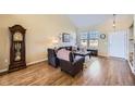 Inviting living room showcasing hardwood floors, large windows, and a traditional grandfather clock at 3751 W 136Th Ave # P3, Broomfield, CO 80023
