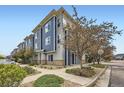 Street view of modern townhomes with blue and gray siding, showcasing the neighborhood's curb appeal at 9300 E Florida Ave # 1101, Denver, CO 80247