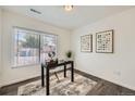 Bright home office with a desk, artwork, and natural light from a large window at 9300 E Florida Ave # 1101, Denver, CO 80247