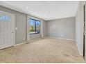 Inviting living room features large window, neutral decor, and an abundance of natural light at 2675 S Carson Way, Aurora, CO 80014