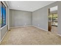 Bright, carpeted living room with large windows, neutral walls, and ample space for furniture at 2675 S Carson Way, Aurora, CO 80014