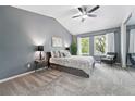 Serene bedroom with vaulted ceilings, plush carpet, and neutral tones at 3300 W Florida Ave # 117, Denver, CO 80219