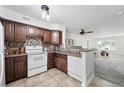 Well-lit kitchen with dark cabinets, neutral countertops, and a stylish backsplash at 3300 W Florida Ave # 117, Denver, CO 80219