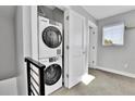 Convenient laundry area featuring a stacked washer and dryer, optimizing space and functionality at 1270 Winona Ct, Denver, CO 80204