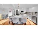 Bright kitchen featuring an island with seating, quartz countertops, and stainless steel appliances at 4642 Everett Ct, Wheat Ridge, CO 80033