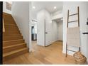 Inviting entryway features wood floors, modern decor, and a staircase leading to the upper level at 1601 Park Ave # 216, Denver, CO 80218