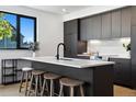 Modern kitchen boasts a large island with seating and sleek cabinetry at 1601 Park Ave # 216, Denver, CO 80218