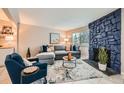 Living room features a comfortable sectional sofa and a stone fireplace at 11919 E Yale Ave, Aurora, CO 80014