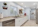Bright kitchen with stainless steel appliances, granite countertops, and ample cabinet space at 2681 Leyden St, Denver, CO 80207