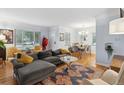 Bright and airy living room features hardwood floors, large windows and stylish decor at 2681 Leyden St, Denver, CO 80207