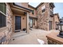 Inviting entryway with a dark door and stone accents at 2543 Eastview Dr, Castle Rock, CO 80104