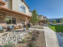 Inviting townhome exteriors, featuring covered porches and professionally maintained landscaping at 11294 Bella Vita Dr, Broomfield, CO 80020