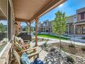 Relaxing front porch with comfortable seating and a tranquil neighborhood view at 11294 Bella Vita Dr, Broomfield, CO 80020