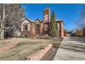 Beautiful brick home featuring a stone walkway, well-maintained landscaping, and a detached garage at 1120 Holly St, Denver, CO 80220