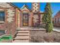 Cozy front porch with brick accents, a wrought iron railing, and a charming entryway with seating at 1120 Holly St, Denver, CO 80220