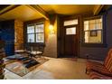 Inviting front porch with chairs, stone accents, and a wood door at 2042 S Clayton St, Denver, CO 80210
