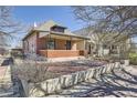 Charming single-Gathering home with a brick facade and covered porch, complemented by mature trees at 3456 Quivas St, Denver, CO 80211