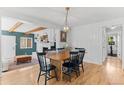 Open dining area with hardwood floors, leading into living space, perfect for Gathering meals and entertaining at 9790 E 5Th Ave, Aurora, CO 80010