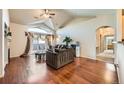 Inviting living room with vaulted ceilings, hardwood floors, and sliding doors to a balcony at 14221 E 1St Dr # 303, Aurora, CO 80011